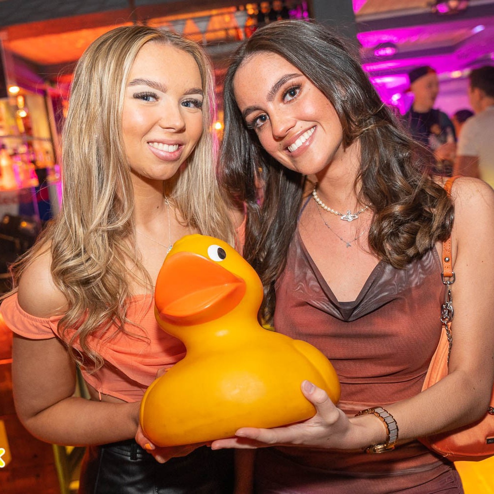 Two girls holding a rubber duck